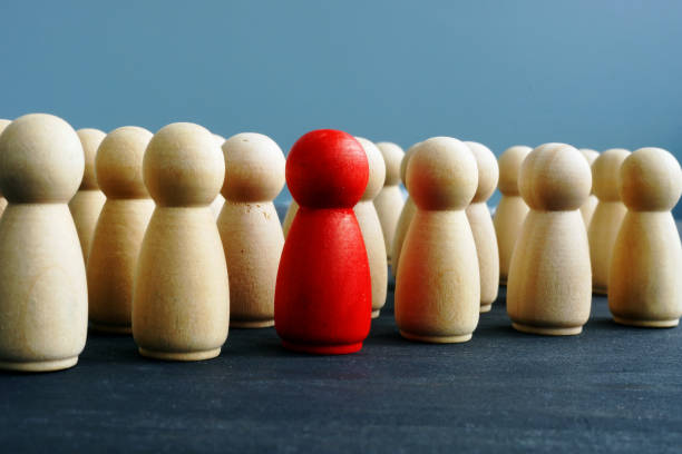 istock Difference, dissimilarity and distinctness concept. Wooden figures on a desk. 1082458222
