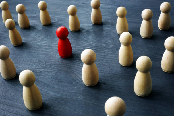istock Uniqueness and differentness concept. Be unique. Wooden figures on a table. 1082458462
