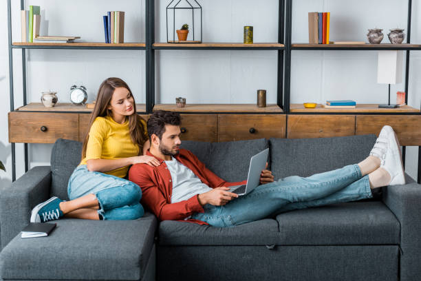 istock young beautiful woman hugging man who using laptop 1082470960