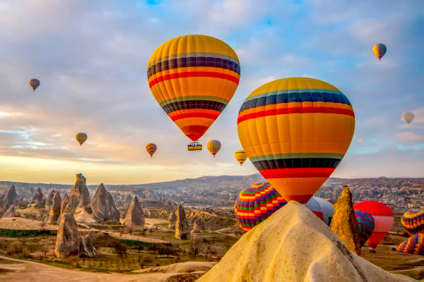 hot air balloon flying over spectacular cappadocia - hot air balloon landscape sunrise mountain imagens e fotografias de stock