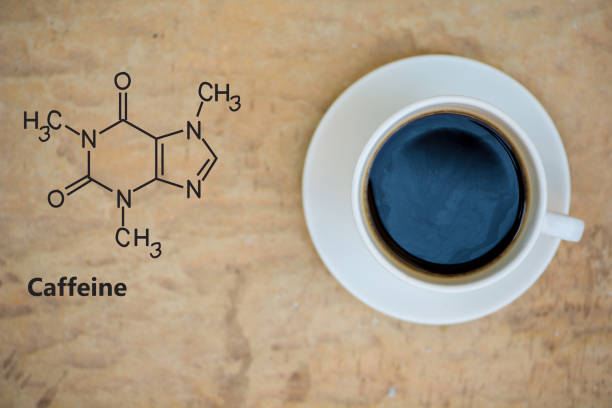 Caffeine chemical structure and a cup of coffee Caffeine chemical structure and a cup of coffee show chemical background caffeine molecule stock pictures, royalty-free photos & images