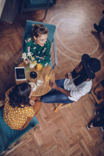 istock Three female friends at cafe having coffee together 1082478230