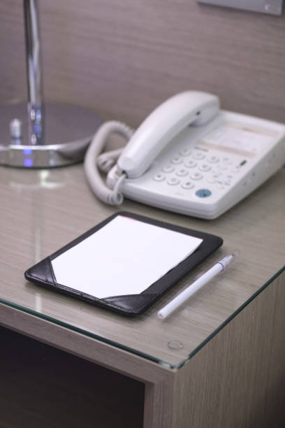 istock Blank note paper and pencil on the beside table in a hotel room. 1082480120