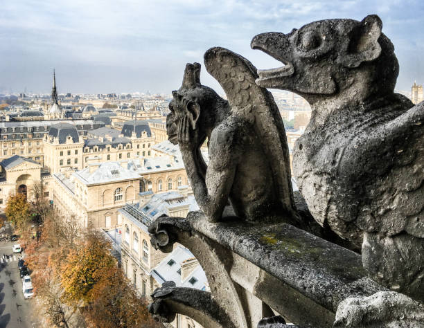 la stryge (strix), the most famous chimera statue of notre-dame de paris cathedral, gazing at the city from the towers gallery. - church close up paris france gothic style imagens e fotografias de stock