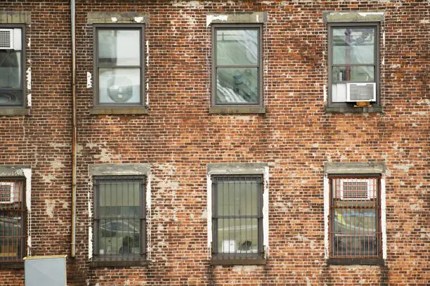 Photo of Close-up view of windows of some apartments. Photo taken from the Brooklyn Bridge in Manhattan, New York, USA.