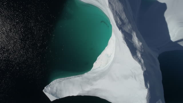 Drone Overhead Shot Of Iceberg - Aerial Footage Lifting up From A Large Iceberg in Greenland, Climate Change, Scoresby Sund