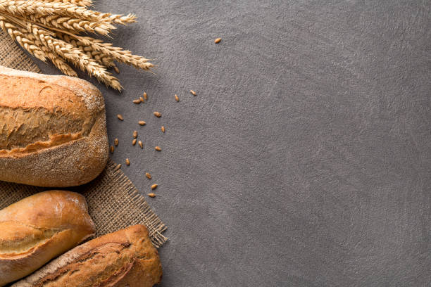 istock Bread background with wheat, aromatic crispbread with grains, copy space. Top view. 1082487542