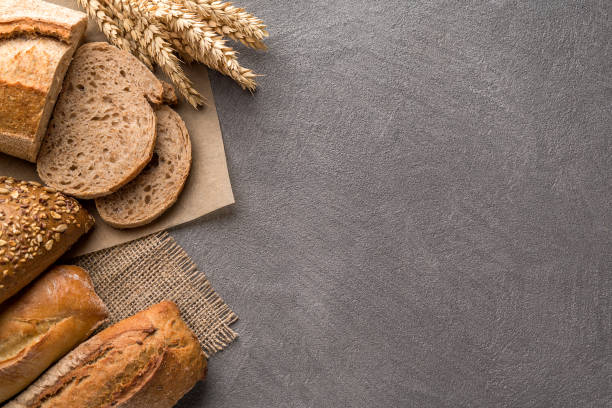 istock Bread background with wheat, aromatic crispbread with grains, copy space. Top view. 1082487644