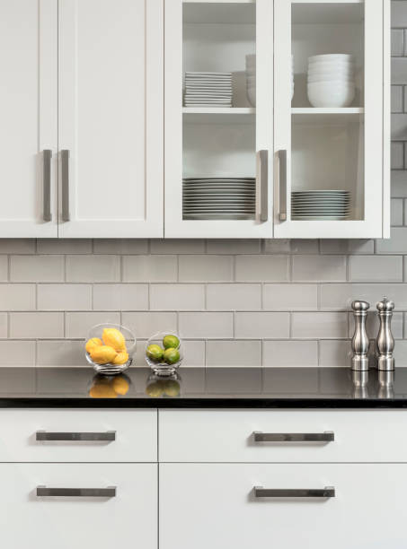 White Kitchen Cabinets Detail of white kitchen cabinets with black counter top salt and pepper shaker stock pictures, royalty-free photos & images