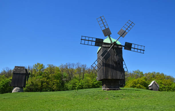 istock Traditional Windmill On Field Against Clear Sky 1082488224