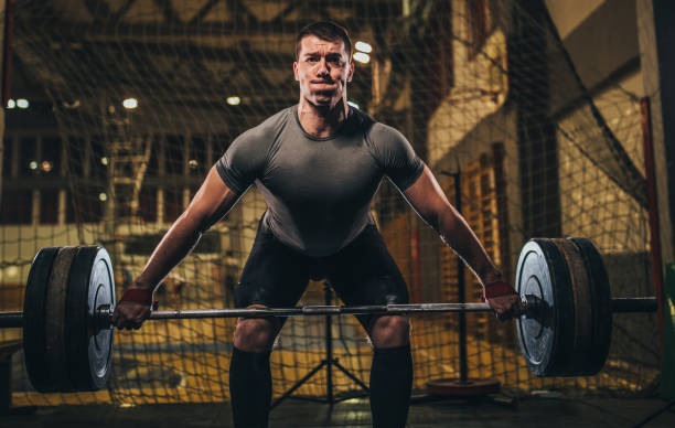 istock Man deadlifting barbell in gym 1082492578