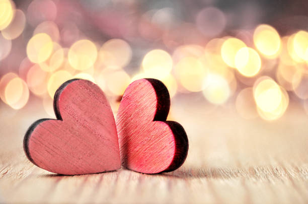 istock Hearts on a wooden surface and background is a bokeh. 1082495120