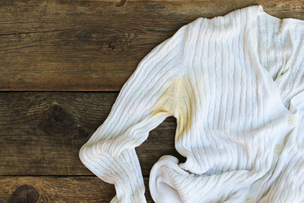 istock Yellow stain on  jacket on the old wooden background. Top view. Flat lay. 1082495528