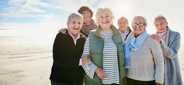 Portrait of a group of happy senior women having a fun day at the beach