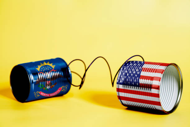 istock tin can phone with USA and North Dakota State Flags. communication concept 1082507028