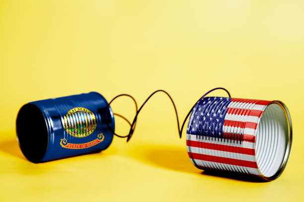 istock tin can phone with USA and Idaho U.S. state Flags. communication concept 1082507042