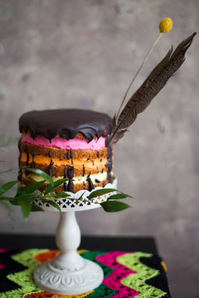 istock boho wedding cake with flowers and feathers 1082515684