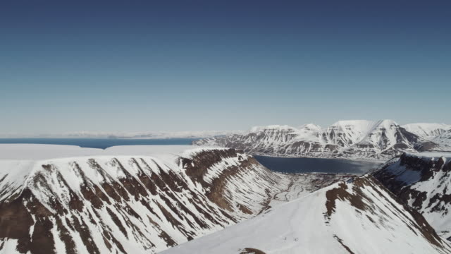 Aerial Drone Footage of Snow Covered Mountains near Longyearbyen in the Arctic, Svalbard, Norway