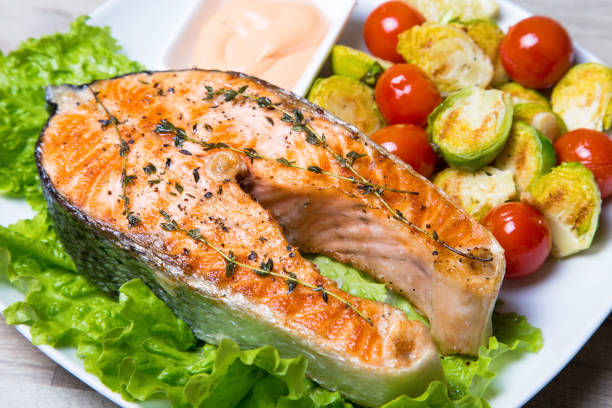 istock Grilled salmon with Brussels sprouts and tomatoes. 1082520974