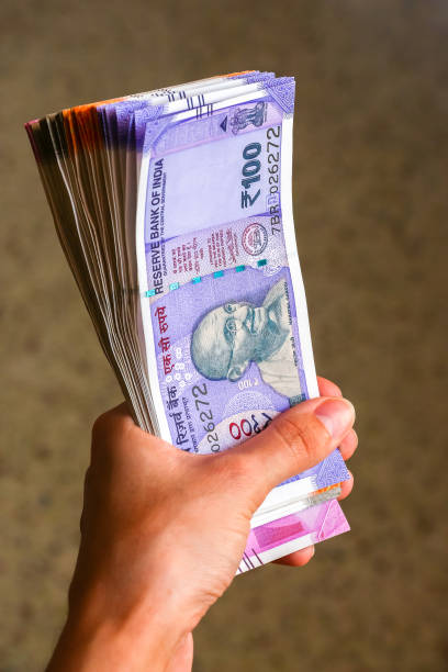 istock Woman's hands holding new indian 100, 200, 500, 2000 rupees banknotes. 1082528120