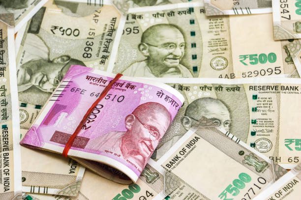 istock New indian 2000 rupees banknotes. 500 rupee banknotes in background. 1082531680