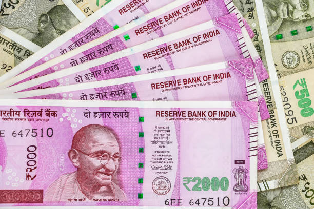 istock New indian 2000 rupees banknotes. 500 rupee banknotes in background. 1082533172