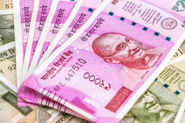 istock New indian 2000 rupees banknotes. 500 rupee banknotes in background. 1082533334