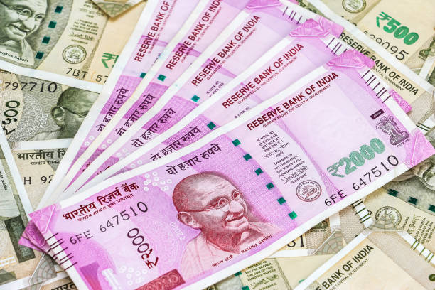 istock New indian 2000 rupees banknotes. 500 rupee banknotes in background. 1082534678