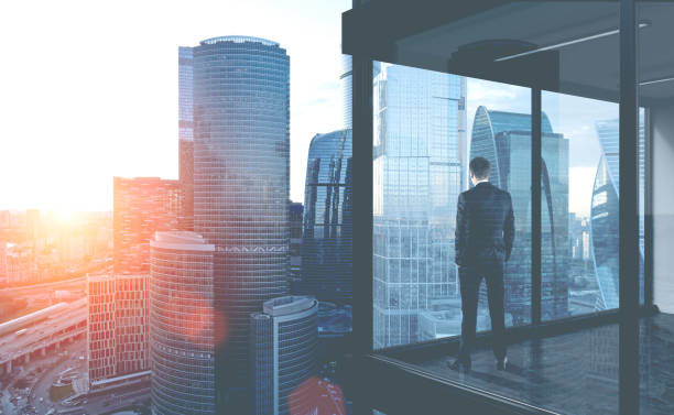 istock Businessman looks in office window 1082538990