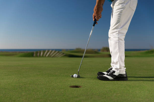 istock Golfer teeing off the ball - ready for putt - links golf 1082543672
