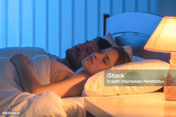 The Couple Sleeping In The Bed Night Time Full Grip Focus Stock Photo - Download Image Now