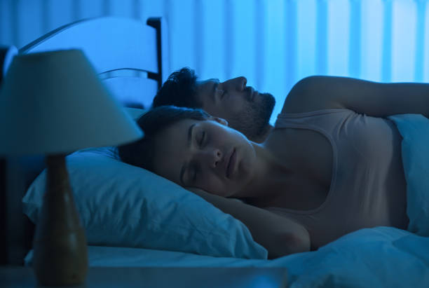 istock The young couple sleeping in the bed. night time, full grip focus 1082546734