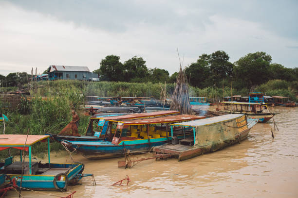 istock Boats Moored In River By Buildings Against Sky 1082547030