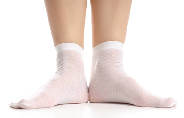 istock Female legs in white nylon socks 1082548338