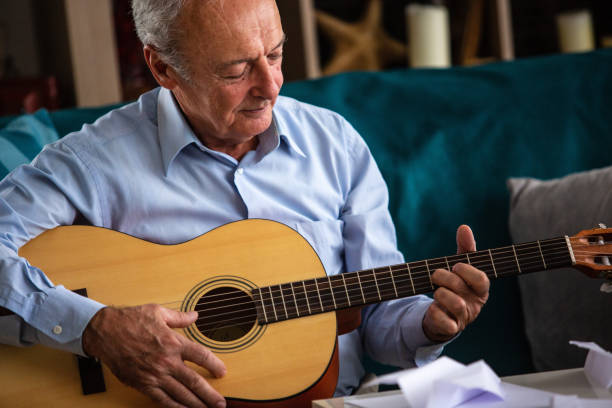 istock Senior man playing the guitar 1082549526