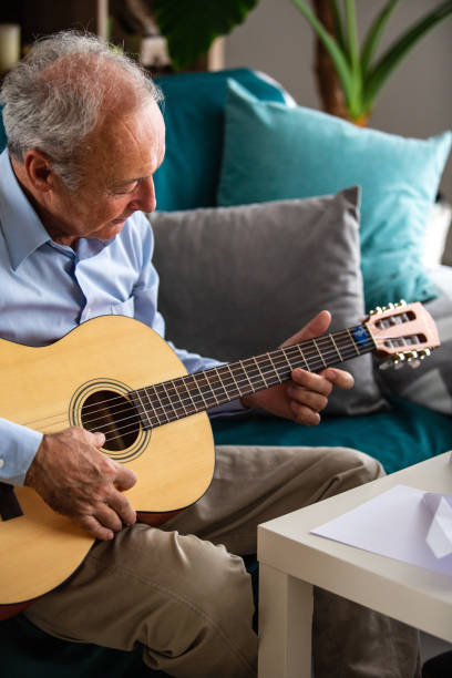 istock Senior man playing the guitar 1082549554