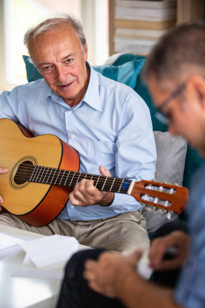 istock Senior man playing the guitar 1082549598
