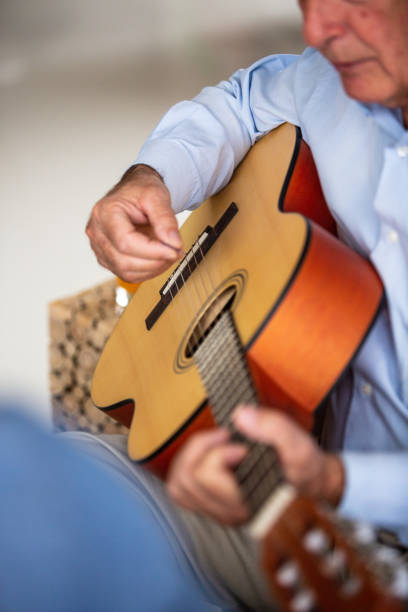 istock Senior man playing the guitar 1082549610