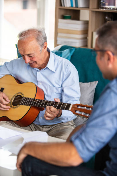 istock Senior man playing the guitar 1082549684