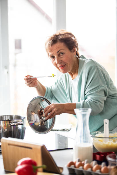 istock Senior woman cooking lunch 1082549722