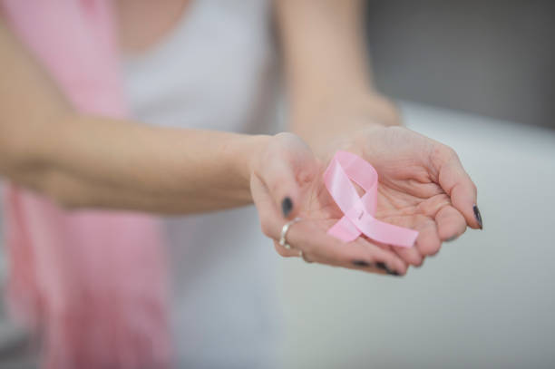 istock Holding breast cancer symbol 1082551320