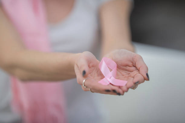 istock Holding a breast cancer ribbon 1082551366