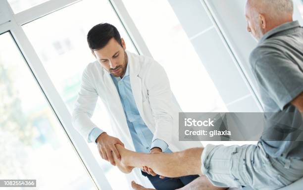 Ankle Examination Stock Photo - Download Image Now - Doctor, Ankle, Pain
