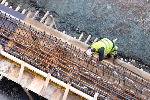 Top view of a builder worker working on a concrete construction under the bridge of Tromso, Norway stock photo