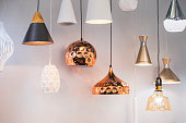 Different modern streamlined mirror copper chandeliers. Bubble metal copper shade pendant