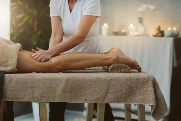 Mid adult woman on anti cellulite massage in beauty salon