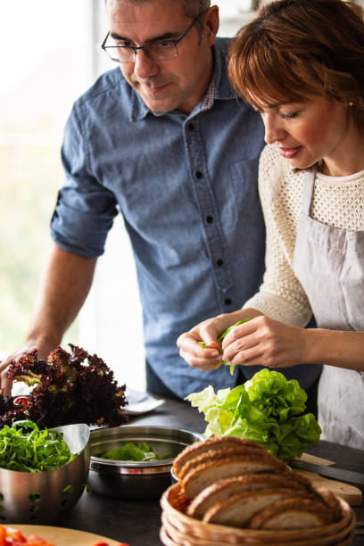 istock Man and woman cooking in the kitchen 1082565870