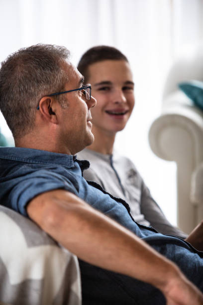 istock Teenage boy and his father talking 1082567436