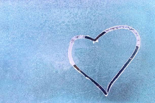 istock drawing hearts on a frozen window. 1082567980