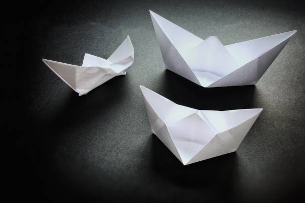 istock Three white boats on a dark shiny background. 1082568984